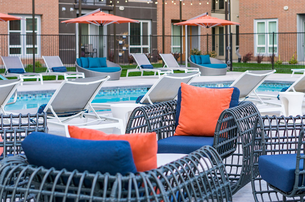 Outdoor pool area with lounge chairs and umbrellas