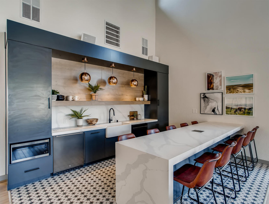 Kitchen with marble counters and dining chairs