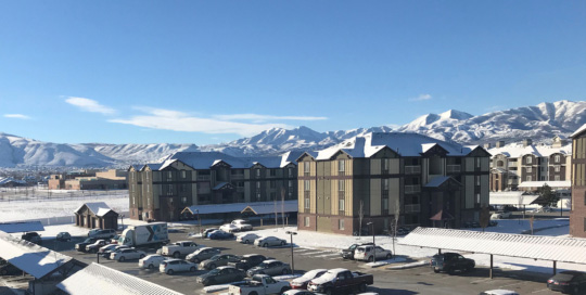 The Emerson Apartments exterior with mountain views