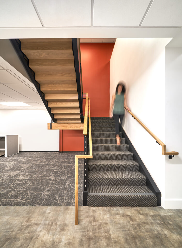 ColRich office stairway with woman coming down stairs